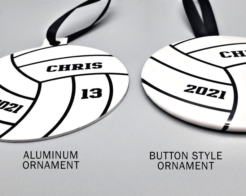 May include: Two volleyball-themed Christmas ornaments, one with an aluminum finish and the other with a button-style finish. Both ornaments feature a black and white volleyball design with the text "CHRIS 13" and "2021" on them.