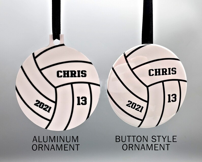 May include: Two volleyball-themed Christmas ornaments, one with a white background and the other with a silver background. Both ornaments feature a black volleyball design with the name "CHRIS" and the number "13" printed on them. The white ornament is labeled "Aluminum Ornament" and the silver ornament is labeled "Button Style Ornament".