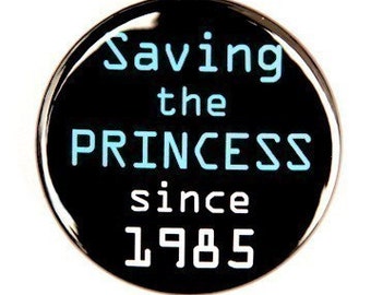 Saving The Princess Since 1985 - Pinback Button Badge 1 1/2 inch 1.5 - Flatback Magnet or Keychain