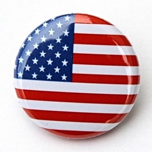 May include: A round button with a red, white, and blue American flag design.