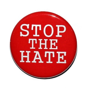May include: A red round button with white text that reads "STOP THE HATE".