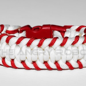 May include: White and red paracord bracelet with a red plastic clasp.