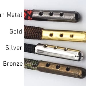 May include: Four different colored metal cord ends with four holes each. The cord ends are gun metal, gold, silver, and bronze.