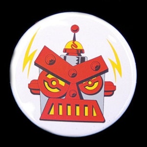 May include: A white button with a red and gray robot face with yellow eyes and a red antenna. The robot has a red and yellow striped mouth and two yellow lightning bolts on either side of the head.
