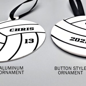 May include: Two volleyball-themed Christmas ornaments, one with an aluminum finish and the other with a button-style finish. Both ornaments feature the name "CHRIS" and the number "13", along with the year "2021".