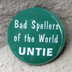 May include: A green button with white text that reads "Bad Spellers of the World UNTIE".