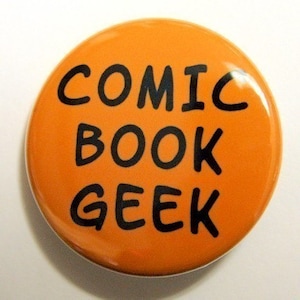 May include: Orange round button with black text that reads "COMIC BOOK GEEK".