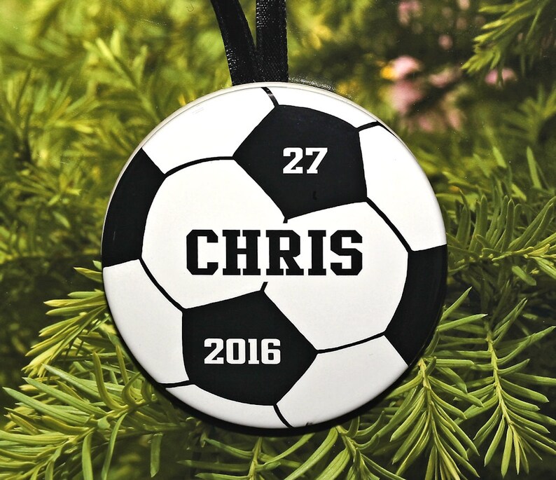 May include: A white and black soccer ball ornament with the number 27, the name "CHRIS", and the year 2016.