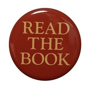 May include: A red button with the text "READ THE BOOK" in gold lettering.