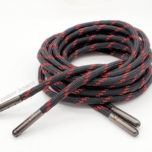 May include: Black and red shoelaces with metal aglets. The shoelaces are made of a durable, braided material.