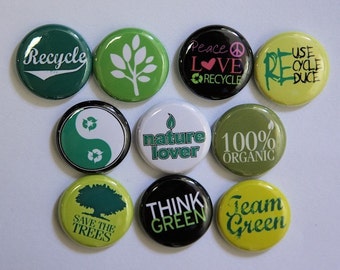 May include: Nine round green, white, and black buttons with various environmental slogans and images. The slogans include "Recycle", "Peace Love Recycle", "Use Recycle Reduce", "Save the Trees", "Nature Lover", "100% Organic", "Think Green", and "Team Green".