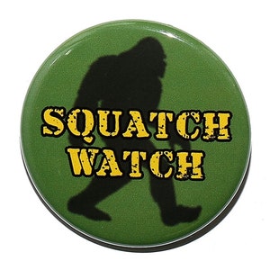 May include: A green button with a silhouette of Bigfoot walking and the text "SQUATCH WATCH" in yellow.