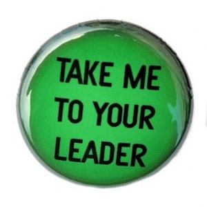 May include: Green button with the text "TAKE ME TO YOUR LEADER" in black.