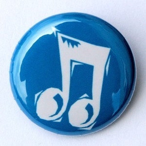 May include: A blue and white music note button. The note is white and the background is blue.