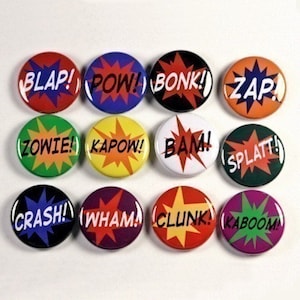 May include: Twelve 1-inch diameter round buttons with colorful backgrounds and white text. The text on the buttons includes "BLAP!", "POW!", "BONK!", "ZAP!", "ZOWIE!", "KAPOW!", "BAM!", "SPLAT!", "CRASH!", "WHAM!", "CLUNK!", and "KABOOM!"
