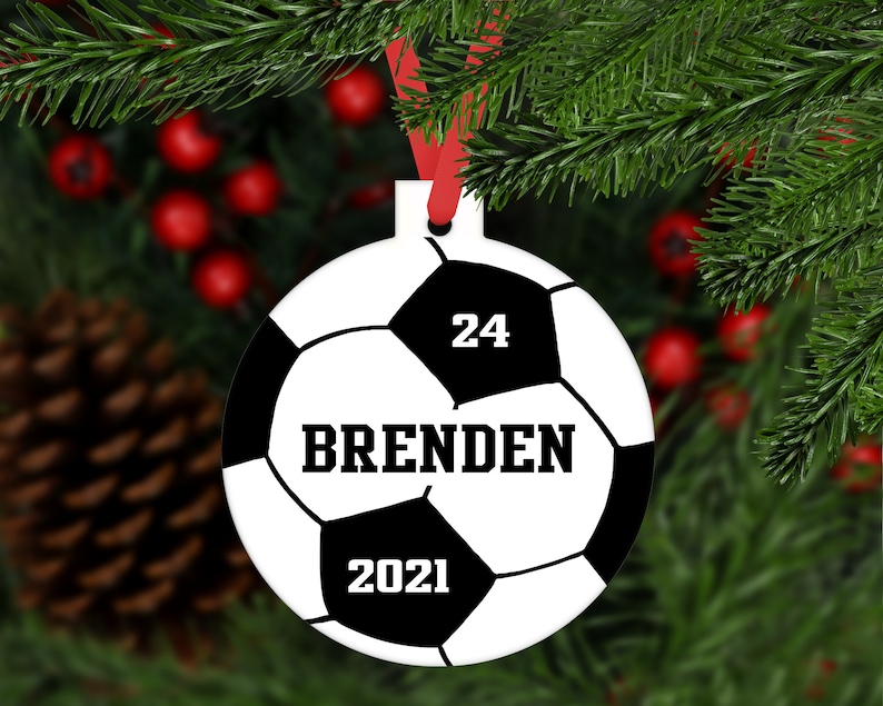 May include: A white and black soccer ball Christmas ornament with the number 24, the name "BRENDEN", and the year 2021 printed on it.