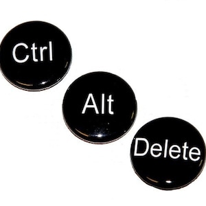 May include: Three black round buttons with white text. The buttons read "Ctrl", "Alt", and "Delete".