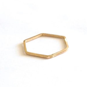 May include: A gold hexagonal ring.