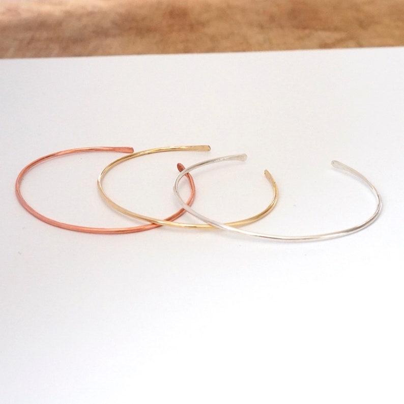 Thin Dainty 1.3mm Cuff Bracelet with Hammered Ends matte solid 0.925 sterling silver (right), brass (center), and Copper (left) 0178 Virginia Wynne Designs VWD