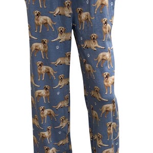May include: Blue pajama pants with a pattern of yellow Labrador Retrievers. The pants have a drawstring waist and pockets.