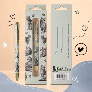 May include: A light green ballpoint pen featuring a silver tabby cat pattern and gold-tone accents, presented in a matching cardboard box. The packaging includes the text "To: From:" and "Write with love, inspired by your furry friend."