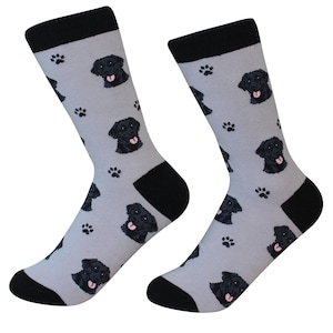 May include: A pair of light gray socks with black accents at the toes, heels, and cuffs. The socks feature a repeating pattern of black Labrador Retriever dog faces and paw prints.