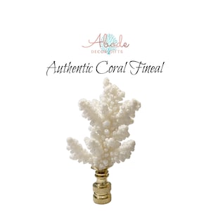 May include: White coral finial with a gold metal base. The coral is a natural piece and has a unique shape. The finial is perfect for adding a touch of coastal style to your home decor.