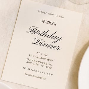 May include: A cream-colored invitation card with black text. The card reads "PLEASE JOIN US FOR AVERY'S Birthday Dinner" with the date, time, and address. The bottom of the card states "RECEPTION TO FOLLOW" and "DRESS CODE: DRESSES."