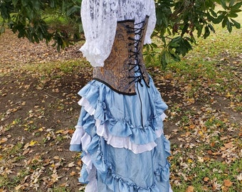 May include: A blue and white layered skirt with ruffles, paired with a brown and gold corset and a white lace top. The skirt is a high-low style, with the front being shorter than the back.