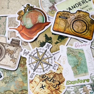 May include: A collection of travel-themed stickers featuring a compass, a camera with the word "TRAVEL", a snail with a globe, and the word "Explore". The stickers have a vintage map design with shades of brown, green, and white.