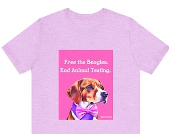 May include: A pale purple t-shirt with a graphic of a beagle wearing a pink bow tie on a pink background. The text "Free the Beagles. End Animal Testing." is displayed above the beagle.