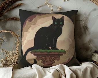 May include: Black cat with green eyes sitting on a decorative pedestal, featured on a square pillow. The pillow has a dark background with a light brown and tan circular design behind the cat. The pedestal is brown with green grass.
