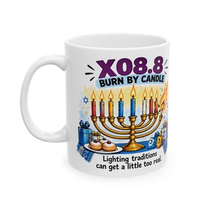 Peut inclure: Un mug en céramique blanche illustré d'une ménorah dorée avec des bougies allumées, des cadeaux bleus et blancs, et deux beignets. Le texte indique X08.8 BURN BY CANDLE et Lighting traditions can get a little too real.