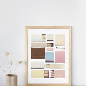 May include: A framed print of a collection of matchboxes in various colors and designs. The matchboxes are arranged in a grid pattern and feature different colors, including yellow, pink, blue, brown, and white.