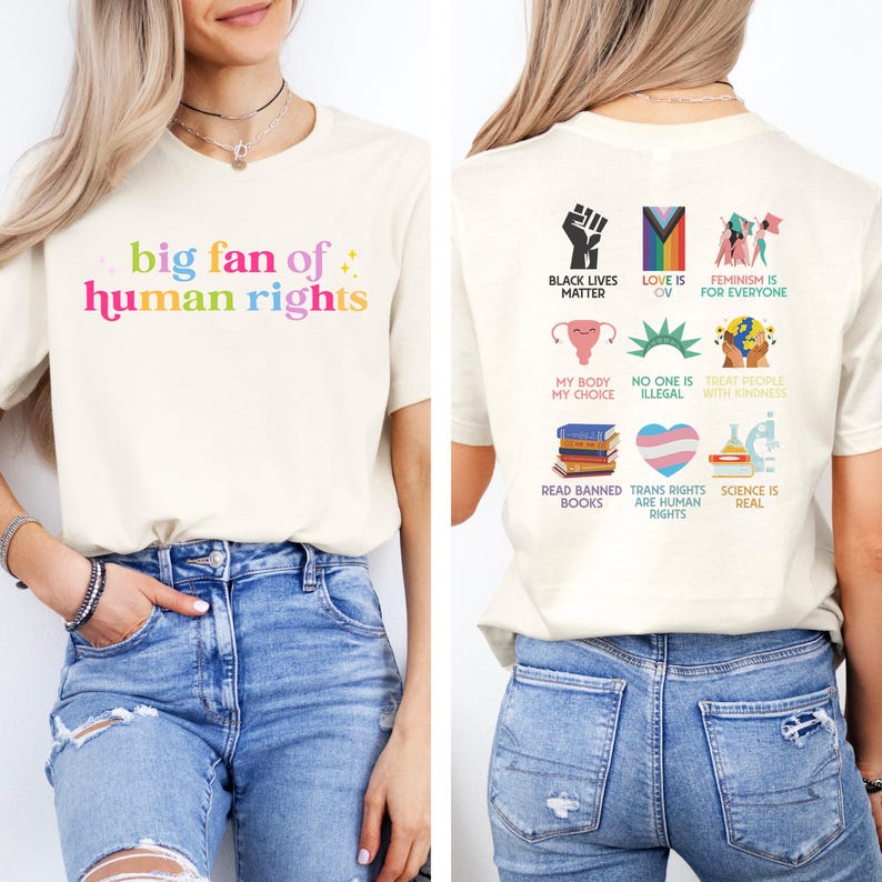 May include: Cream-coloured t-shirt with the text "big fan of human rights" in colourful letters. The back of the shirt features various graphics and phrases, including "Black Lives Matter," "Love is Love," and "Feminism is for Everyone."