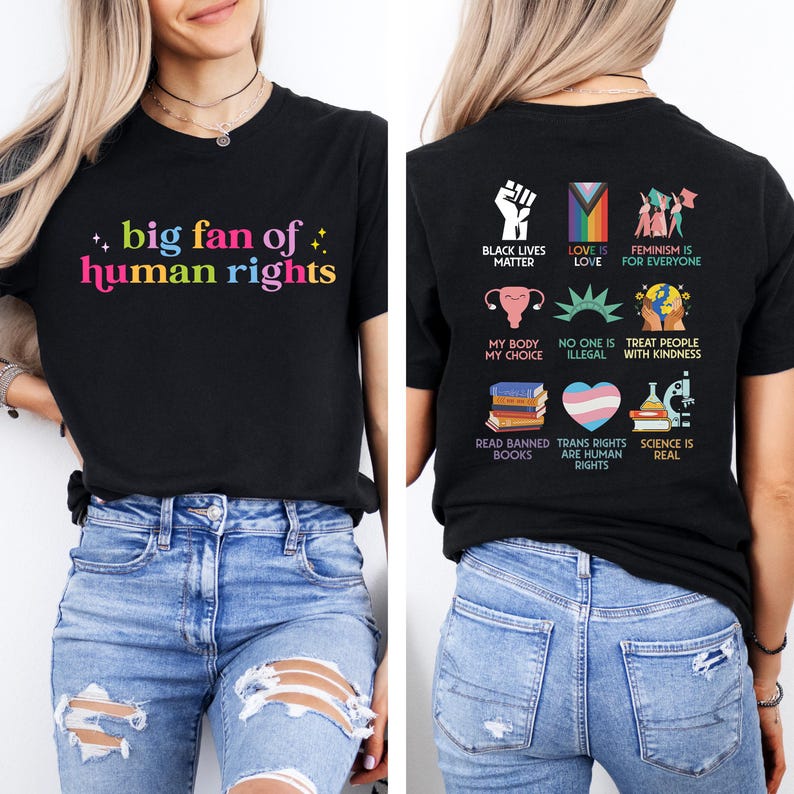 May include: Black t-shirt with the text "big fan of human rights" in colourful letters. The back of the shirt features various graphics and phrases, including "Black Lives Matter," "Love is Love," and "Feminism is for Everyone."