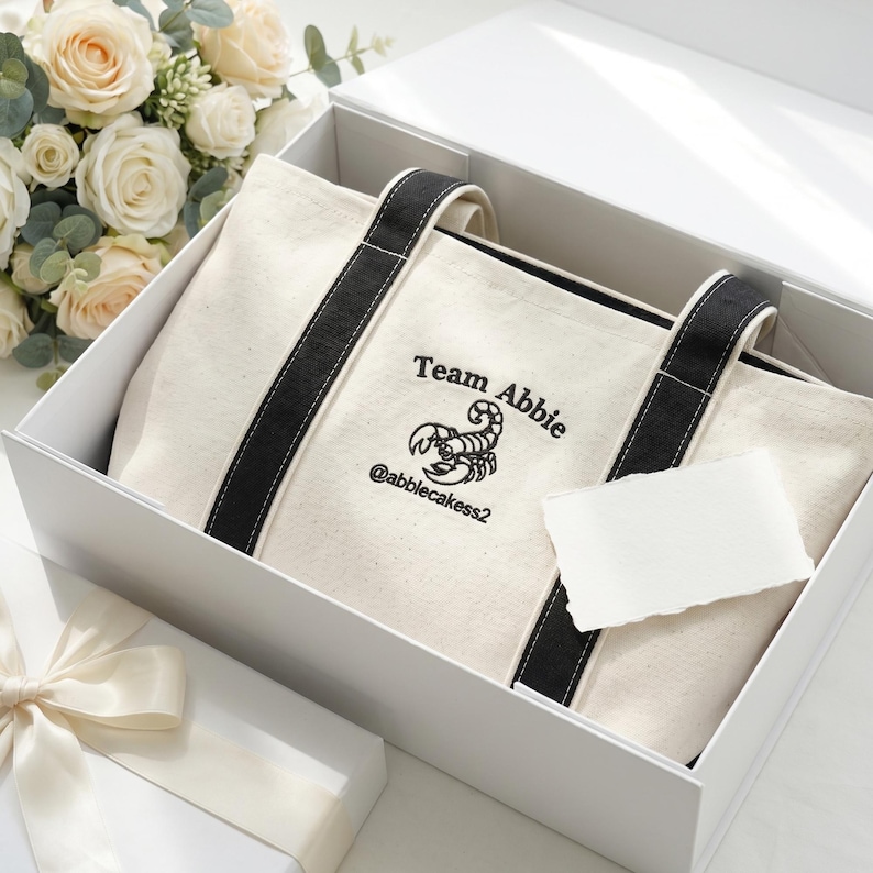 Custom embroidered logo tote bag packaged in gift box with flowers, branded business gift idea, perfect for client appreciation or team gifts