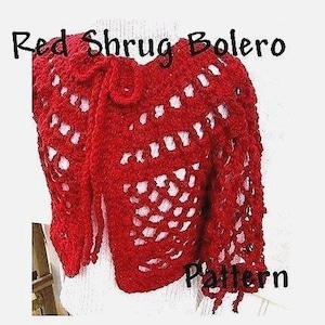 May include: Red crochet shrug bolero pattern. The shrug is made with a lacy stitch and has a tie at the neck.