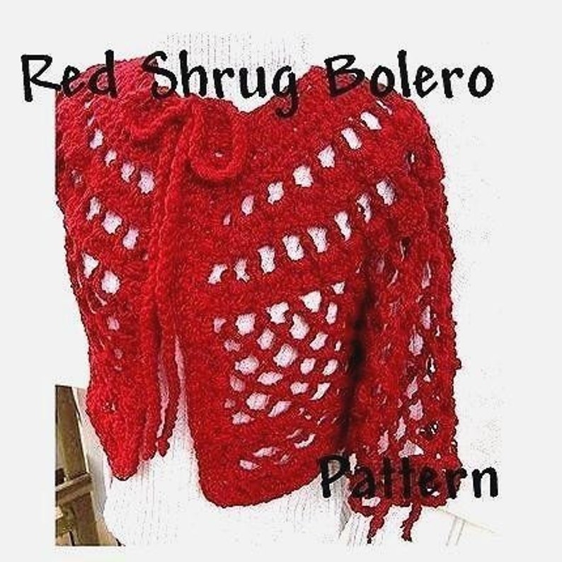 May include: Red crochet shrug bolero pattern. The shrug is made with a lacy stitch and has a tie at the neck.