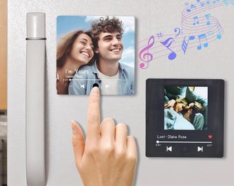 May include: Two square photo magnets with a black frame and a music player interface. The top magnet features a couple and the text "I'm Yours - Jason Mraz". The bottom magnet features a couple in bed and the text "Lost - Blake Rose".