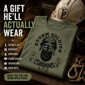 Op de afbeelding: Een olijfgroen t-shirt met een afbeelding van een bebaarde schedel met een helm en de tekst STORM SOLDIER LINEMAN. Het shirt bevat de tekst A GIFT HE'LL ACTUALLY WEAR, FATHER'S DAY, BIRTHDAYS, CHRISTMAS, STORM SEASON, GRADUATION, CREW GIFTS, MADE FOR THE LINE. WORN WITH PRIDE.