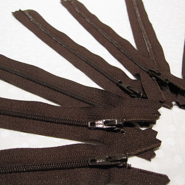 Nine dark brown zippers that are 7" long