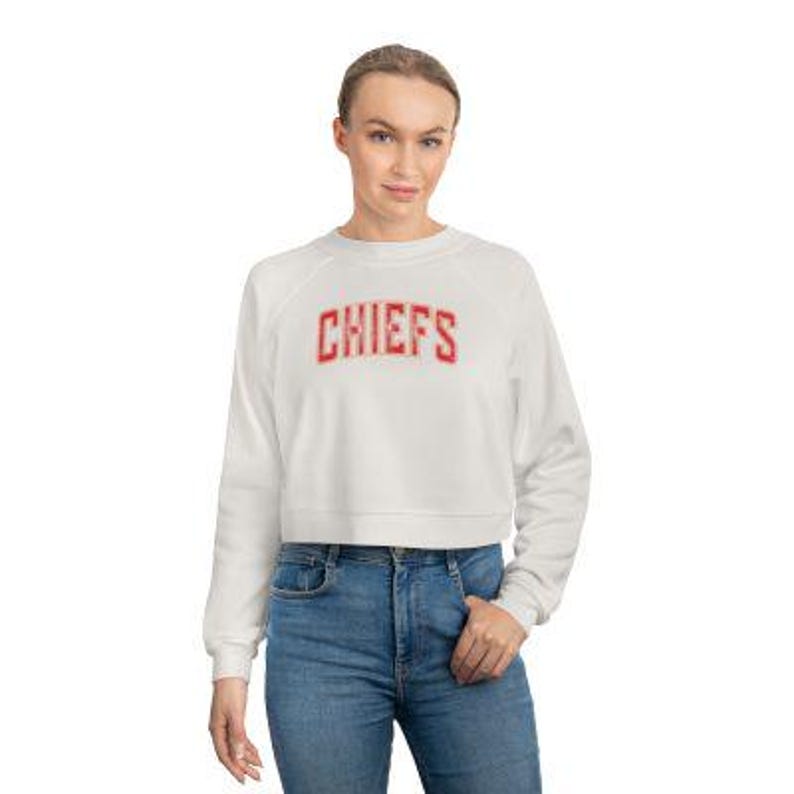 May include: White cropped sweatshirt with red "CHIEFS" text on the front.