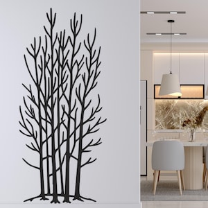 May include: Black metal tree wall art. The artwork features a stylized depiction of a group of trees with intricate branches and roots. The piece is mounted on a white wall, adding a modern touch to the decor.