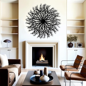 May include: Black metal wall art in the shape of a large, intricate branch design. The art is hanging above a fireplace in a living room with brown leather furniture and a coffee table.