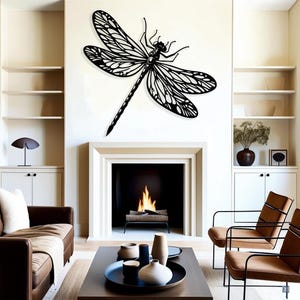 May include: Black metal dragonfly wall decor with intricate details, mounted above a fireplace in a living room setting.