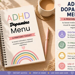 Op de afbeelding: Een spiraalgebonden notitieboek met de titel ADHD Dopamine Menu A Printable Toolkit en een pastelkleurige regenboogafbeelding. De kaft bevat tekst over het stimuleren van motivatie en emotionele regulatie. Een roze pen ligt ernaast.