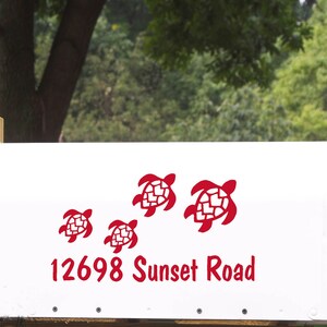 May include: White mailbox with red turtle decals and the address 12698 Sunset Road.
