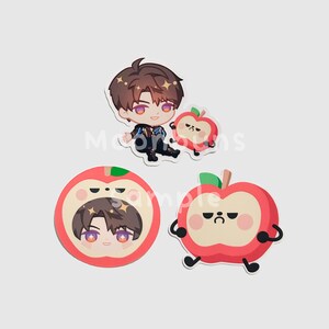 May include: A collection of stickers featuring a cartoon character and apple designs. The character has brown hair and is wearing a black and blue outfit. The apples are red with green leaves and have various facial expressions.