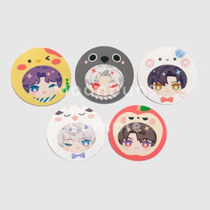 May include: Five round, colorful character designs. Each features a cartoon face with a different animal-themed hat: a chick, a seal, a bear, a sheep, and an apple. The characters have various hair colors and wear bow ties.